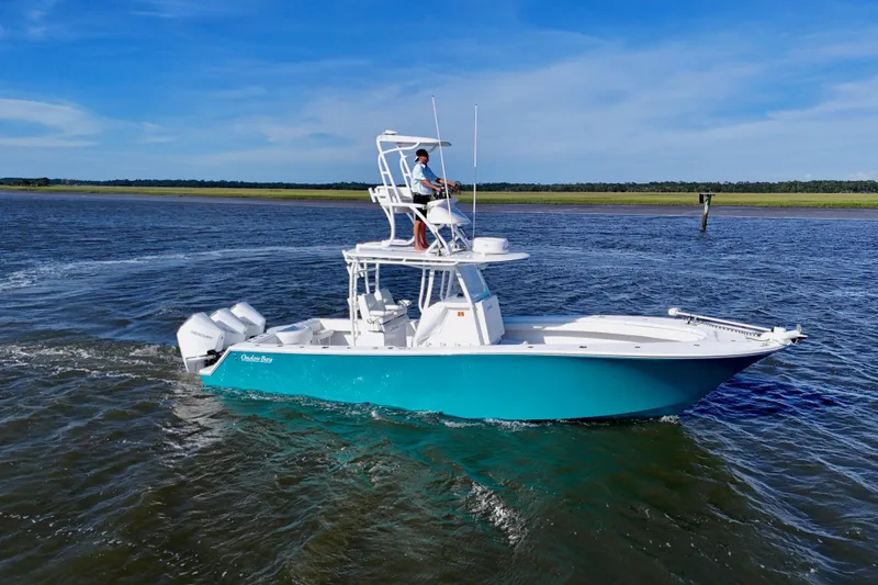 Slide: The Image of 2021 Onslow Bay 33 Tournament boat cruising on open water under clear blue skies. - 13