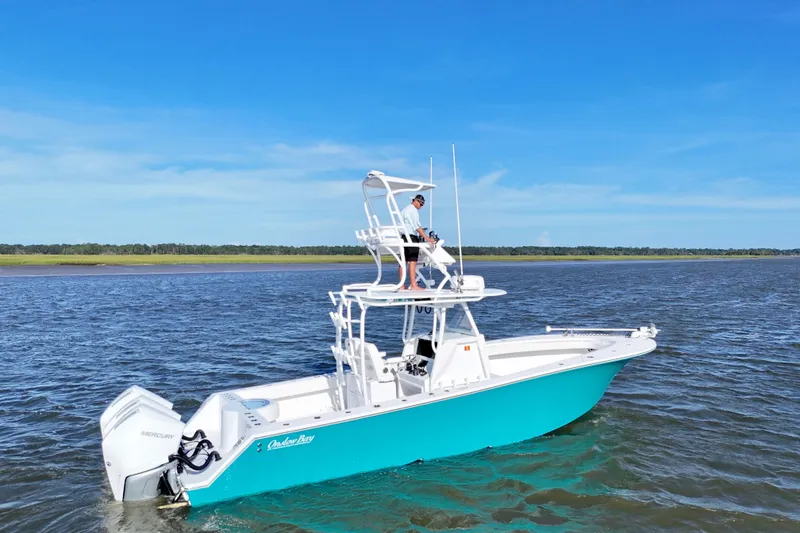 Slide: The Image of 2021 Onslow Bay 33 Tournament boat on water, featuring dual Mercury engines. - 16