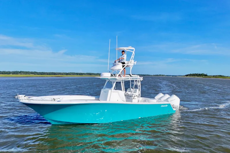 Slide: The Image of 2021 Onslow Bay 33 Tournament boat cruising on open water under clear blue sky. - 7