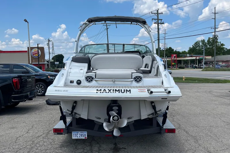 Slide: The Image of 2022 Crownline 280 SS boat parked in a lot, rear view with visible propeller. - 19