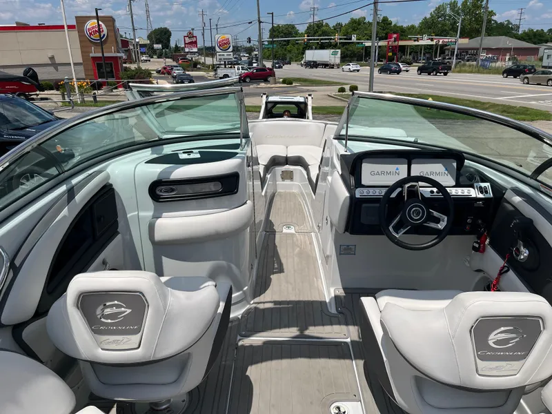 Slide: The Image of 2022 Crownline 280 SS boat interior with Garmin navigation, parked near a Burger King. - 2