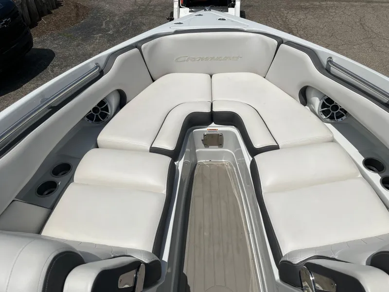 Slide: The Image of 2022 Crownline 280 SS boat interior with white cushioned seating and cup holders. - 4