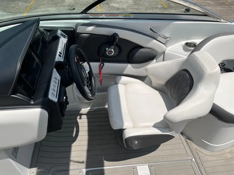 Slide: The Image of 2022 Crownline 280 SS boat interior with steering wheel and captain's seat. - 9