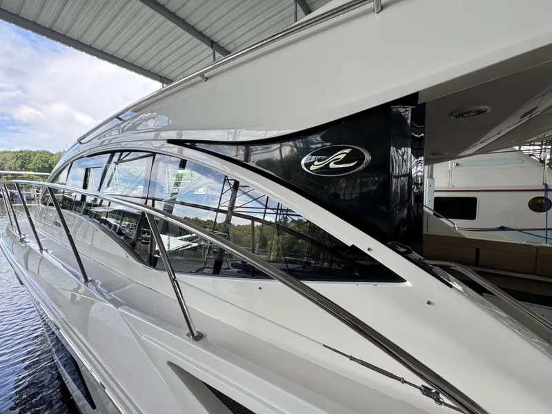 Slide: The Image of 2017 Sea Ray Sundancer 400 yacht docked under a covered marina. - 11