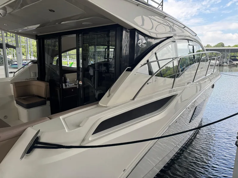 Slide: The Image of 2017 Sea Ray Sundancer 400 yacht docked, showcasing sleek design and luxurious interior. - 12
