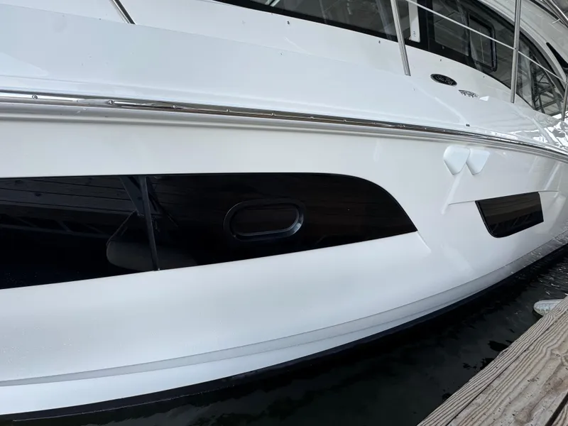 Slide: The Image of 2017 Sea Ray Sundancer 400 yacht docked, showcasing sleek white hull design. - 13