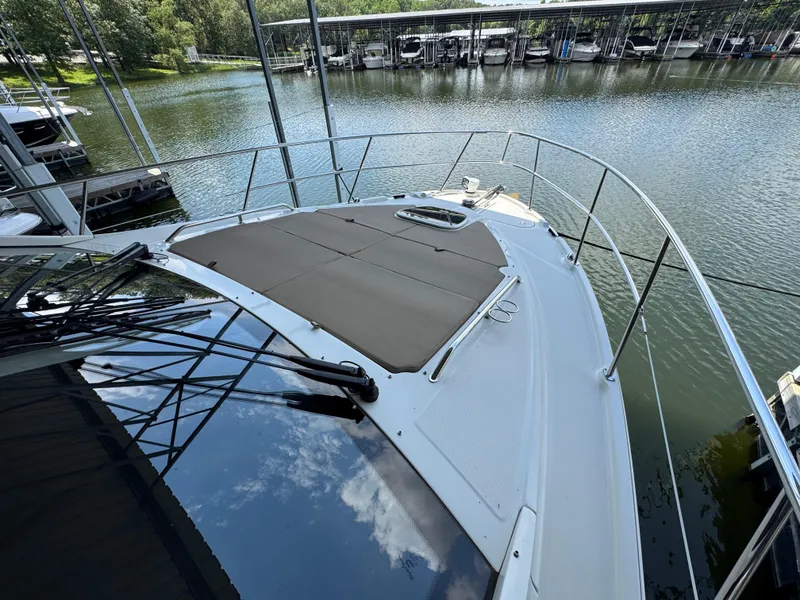 Slide: The Image of 2017 Sea Ray Sundancer 400 yacht docked by a serene marina. - 15