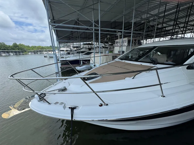 Slide: The Image of 2017 Sea Ray Sundancer 400 docked in a marina under a covered structure. - 16