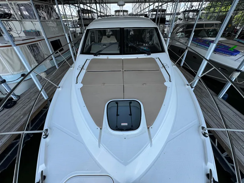 Slide: The Image of 2017 Sea Ray Sundancer 400 yacht docked, featuring spacious deck and sleek design. - 19