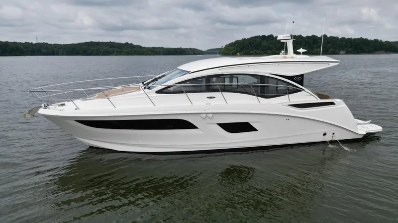 Slide: The Image of 2017 Sea Ray Sundancer 400 yacht on a calm lake under cloudy skies. - 2