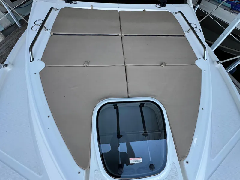 Slide: The Image of 2017 Sea Ray Sundancer 400 deck with cushioned sunbathing area and hatch window. - 20