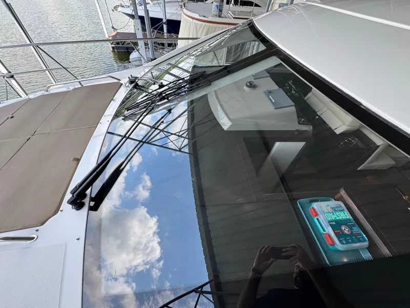 Slide: The Image of 2017 Sea Ray Sundancer 400 yacht with reflective windshield and visible interior details. - 24