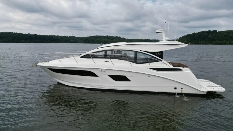Slide: The Image of 2017 Sea Ray Sundancer 400 yacht on a calm lake under cloudy skies. - 3