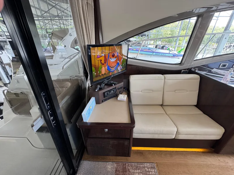 Slide: The Image of Interior of 2017 Sea Ray Sundancer 400 with TV and white seating area. - 36