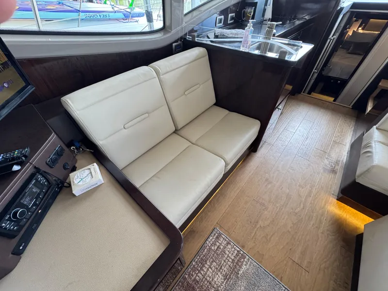 Slide: The Image of 2017 Sea Ray Sundancer 400 interior with beige seating and wooden flooring. - 37