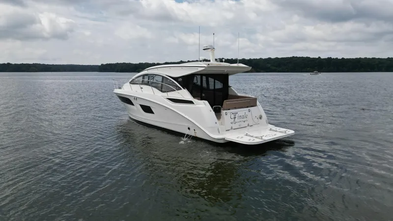 Slide: The Image of 2017 Sea Ray Sundancer 400 yacht cruising on a calm lake under cloudy skies. - 4
