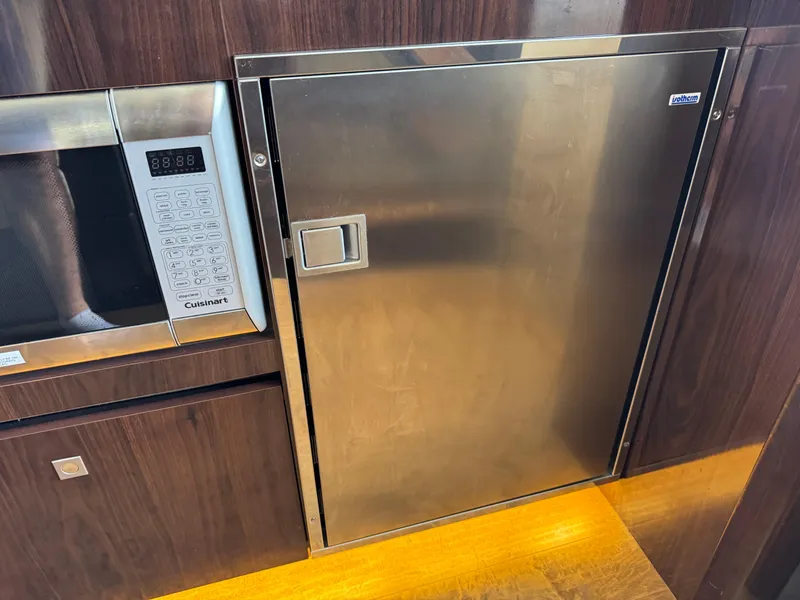 Slide: The Image of 2017 Sea Ray Sundancer 400 kitchen with stainless steel fridge and Cuisinart microwave. - 42