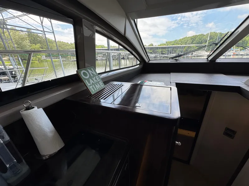 Slide: The Image of Interior of 2017 Sea Ray Sundancer 400 yacht with lake view and "On Lake Time" sign. - 44