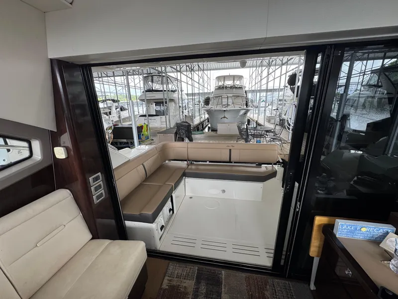 Slide: The Image of 2017 Sea Ray Sundancer 400 interior with spacious seating and marina view. - 46