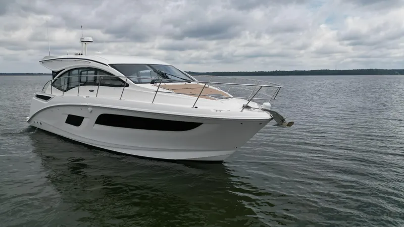 Slide: The Image of 2017 Sea Ray Sundancer 400 yacht cruising on calm waters under cloudy skies. - 6