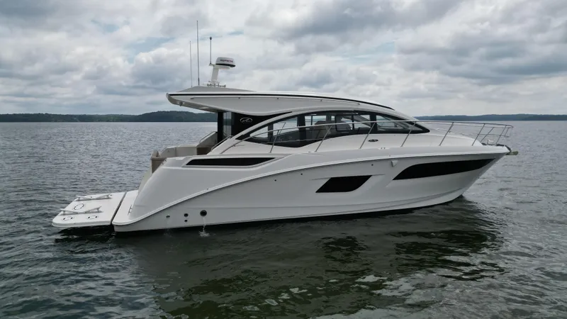 Slide: The Image of 2017 Sea Ray Sundancer 400 yacht on calm water under cloudy skies. - 7