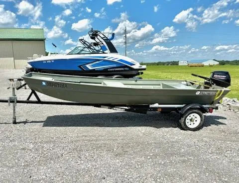 The Image of 2022 Gamefisherman J 1436 boat on trailer, parked outdoors under a blue sky. - 1