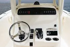 Slide: The Image of 2026 Grady-White Fisherman 236 boat interior with cushioned seating and speakers. - 11