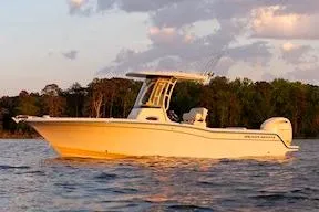 Slide: The Image of 2026 Grady-White Fisherman 236 boat displayed at an indoor boat show. - 3