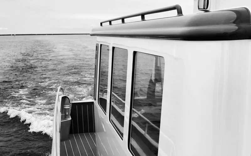 Slide: The Image of Bestevaer 53 M/Y 2026 yacht cruising on open water, side view, black and white. - 33