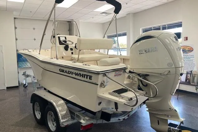 Slide: The Image of 2026 Grady-White Fisherman 180 boat with Yamaha engine on trailer in showroom. - 1