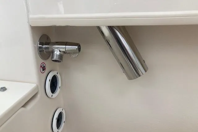 Slide: The Image of 2026 Grady-White Fisherman 180 boat interior, featuring stainless steel fittings and drainage outlets. - 13