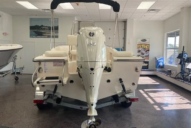 Slide: The Image of 2026 Grady-White Fisherman 180 boat displayed indoors, rear view with motor. - 2