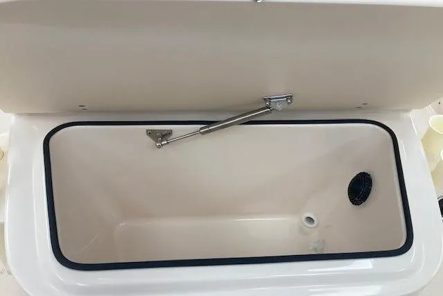 Slide: The Image of 2026 Grady-White Fisherman 180 boat storage compartment, open lid, interior view. - 7