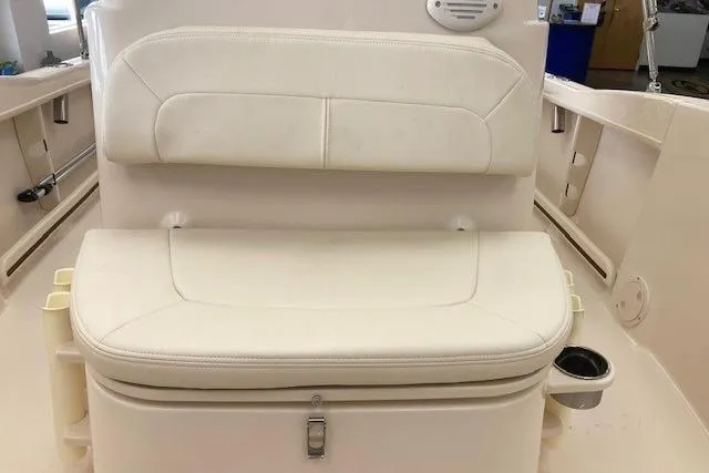 Slide: The Image of 2026 Grady-White Fisherman 180 boat seat with white cushioned design and storage compartment. - 8