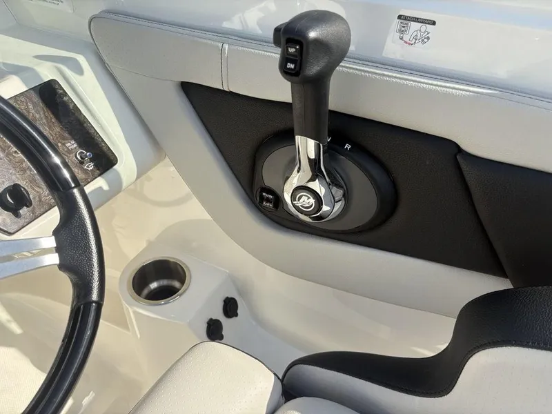 Slide: The Image of 2021 Sea Ray SPX 190 boat control panel with steering wheel and throttle lever. - 11