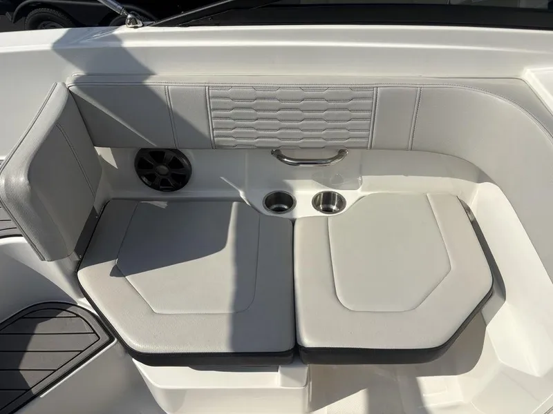 Slide: The Image of 2021 Sea Ray SPX 190 boat seating area with cup holders and speaker. - 13
