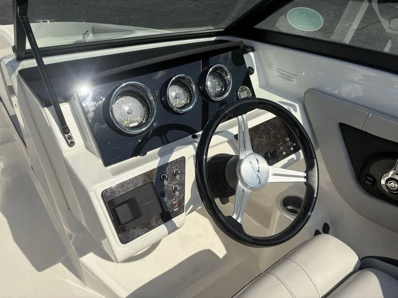 Slide: The Image of 2021 Sea Ray SPX 190 dashboard with steering wheel and instrument panel. - 16