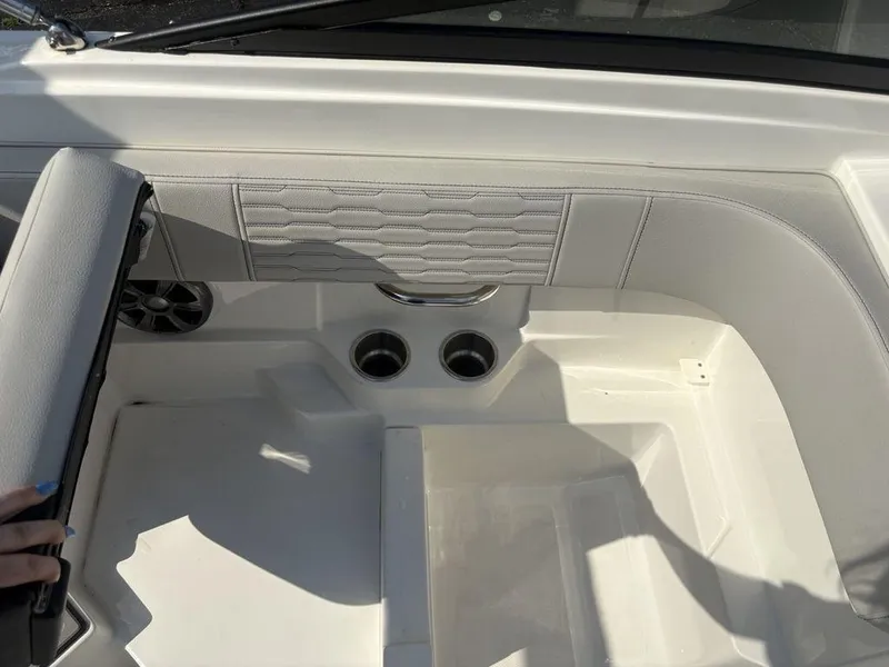 Slide: The Image of Interior of a 2021 Sea Ray SPX 190 boat, featuring white seating and cup holders. - 17