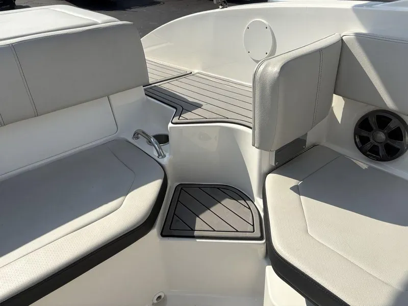 Slide: The Image of Interior seating of a 2021 Sea Ray SPX 190 boat, featuring cushioned seats and speaker. - 19