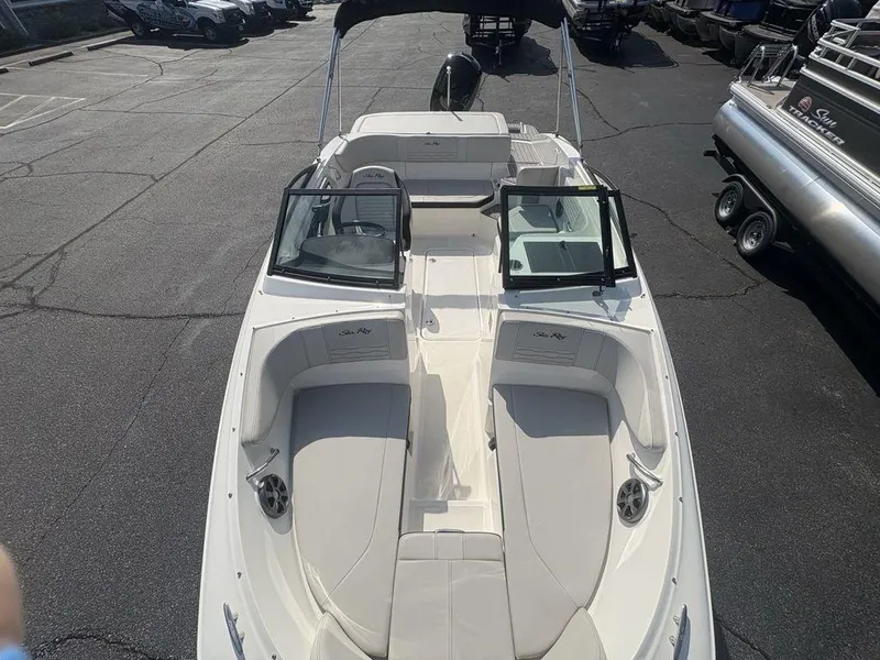 Slide: The Image of 2021 Sea Ray SPX 190 boat with open deck and seating, parked in a lot. - 22