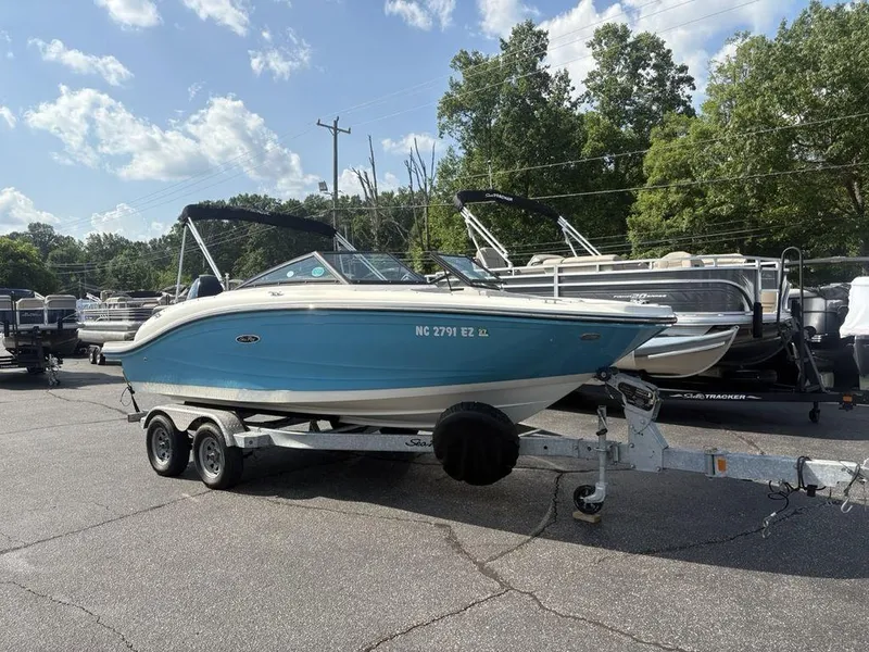 Slide: The Image of 2021 Sea Ray SPX 190 boat on trailer, parked outdoors under a sunny sky. - 3