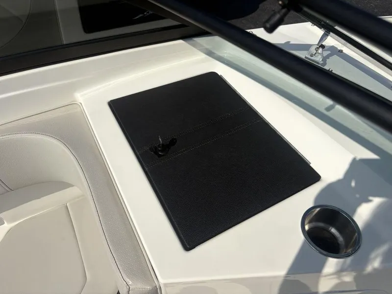 Slide: The Image of 2021 Sea Ray SPX 190 boat dashboard with black panel and cup holder. - 6