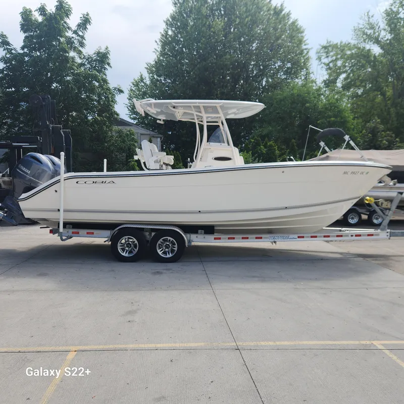 Slide: The Image of 2018 Cobia 261 Center Console boat on trailer, parked outdoors. - 1