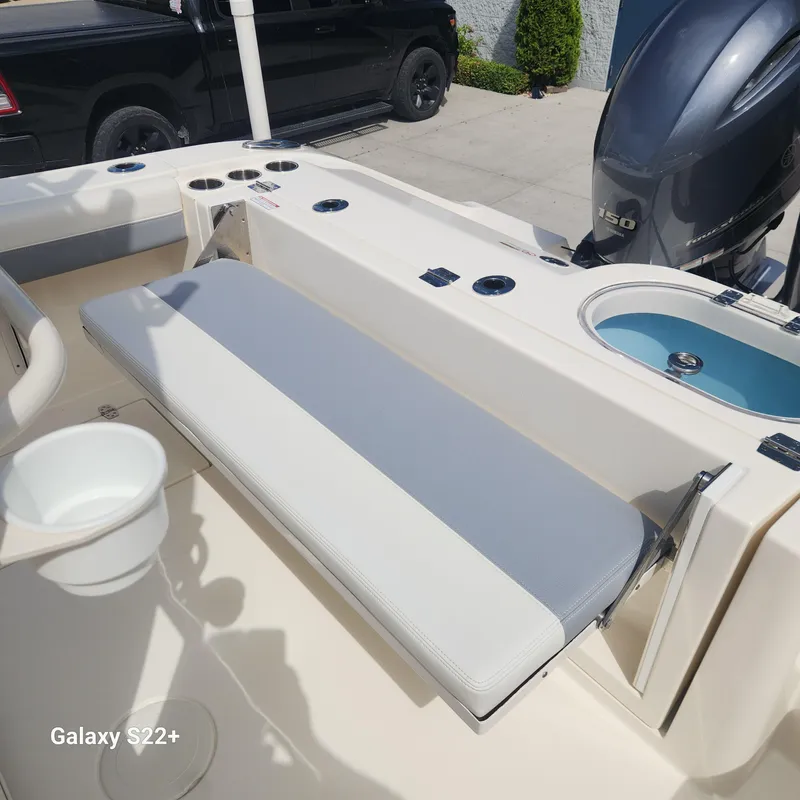 Slide: The Image of 2018 Cobia 261 Center Console boat interior with seating and motor, photographed with Galaxy S22+. - 11