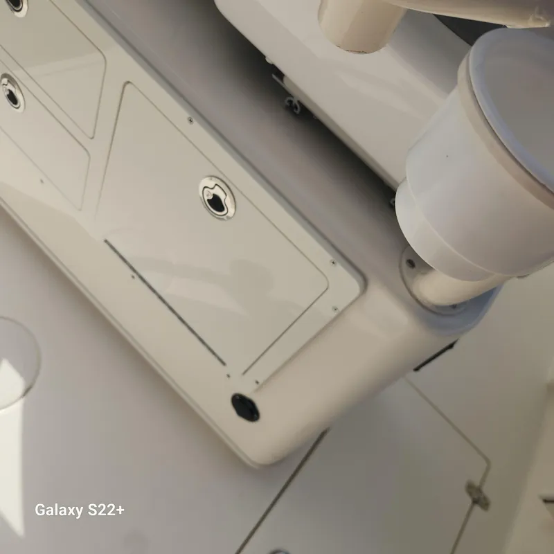 Slide: The Image of 2018 Cobia 261 Center Console boat interior with storage compartments. - 12