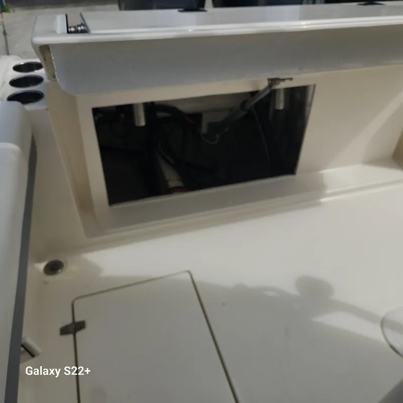 Slide: The Image of 2018 Cobia 261 Center Console boat interior with open storage compartment. - 13