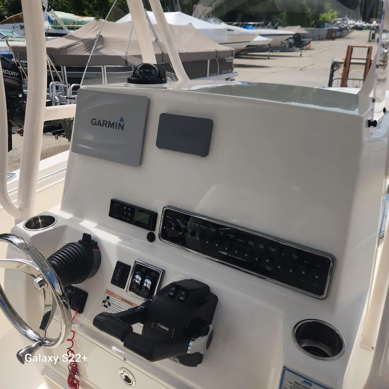 Slide: The Image of 2018 Cobia 261 Center Console helm with Garmin navigation and Yamaha controls. - 15