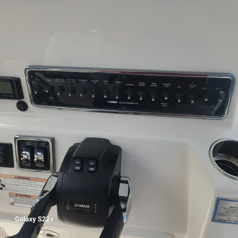 Slide: The Image of 2018 Cobia 261 Center Console dashboard with Yamaha controls and switch panel. - 17