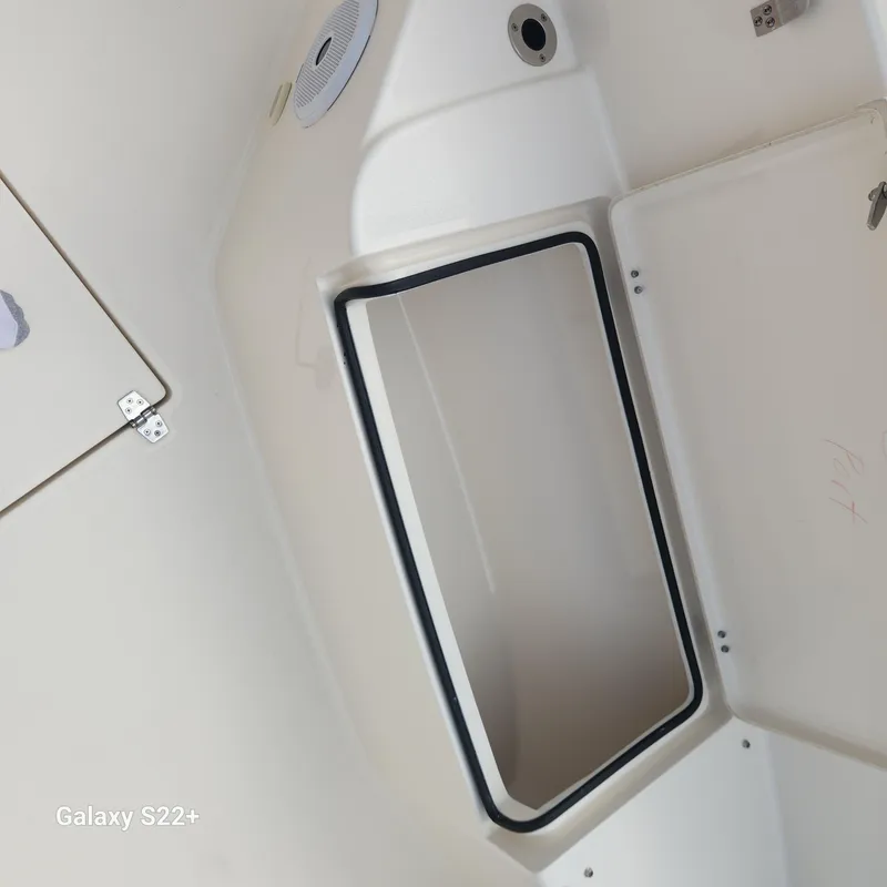 Slide: The Image of Interior view of a 2018 Cobia 261 Center Console boat compartment. - 23