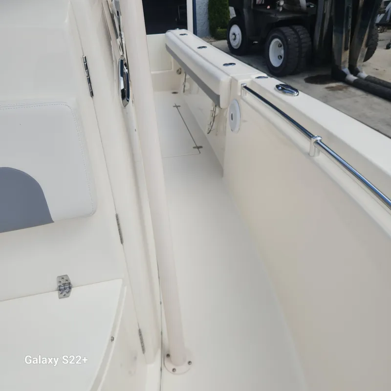 Slide: The Image of 2018 Cobia 261 Center Console boat interior with seating and railings. - 26